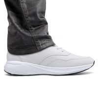 White sneaker worn with dark jeans  7cm taller