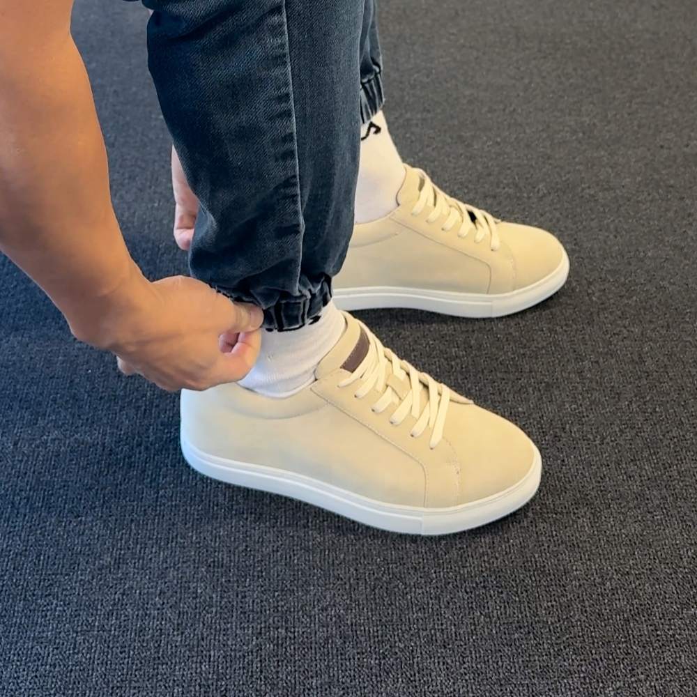 Beige  sneakers with 7cm height worn with denim pants