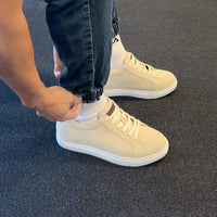 Beige  sneakers with 7cm height worn with denim pants