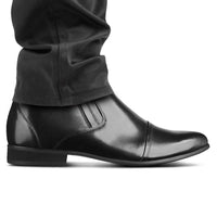 Mr. Ferras black elevator boots worn with formal pants, highlighting height boost and sleek design.