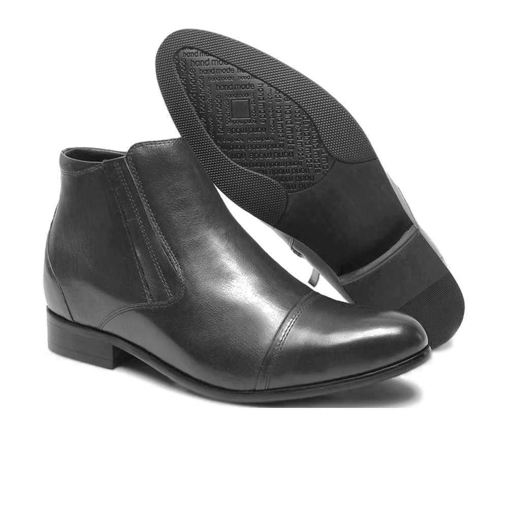 Pair of Mr. Ferras black vegan elevator boots displaying hidden lift insole and elegant design.