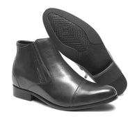 Pair of Mr. Ferras black vegan elevator boots displaying hidden lift insole and elegant design.