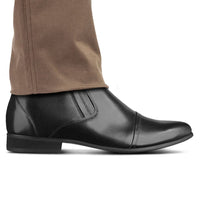 Mr. Ferras black vegan boots worn with formal pants, highlighting height boost and sleek design