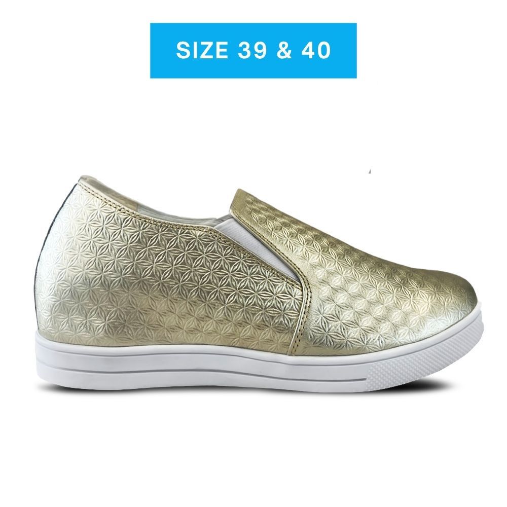 Gold patterned slip-on shoe with white sole on a white background