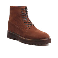 Close-up of Mr. Moses brown boots showing lace-up detail and suede texture