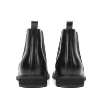 Black leather elevator boots for a sophisticated office look